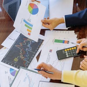 Business professionals analyzing financial charts and graphs during a meeting.